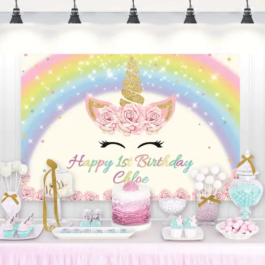 Unicorn-themed birthday backdrop with pastel rainbow, gold horn, and floral ears – perfect for first birthday parties and unicorn celebrations