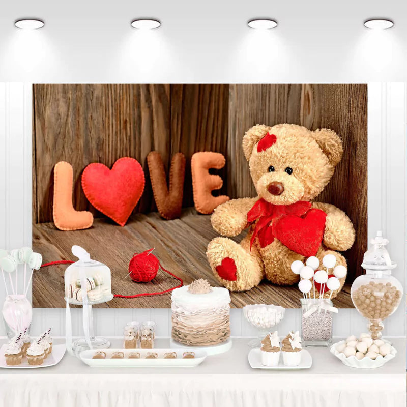 Valentine's Day backdrop with a cute teddy bear holding a heart, wooden background, and heart-shaped decorations spelling LOVE – perfect for romantic photo sessions