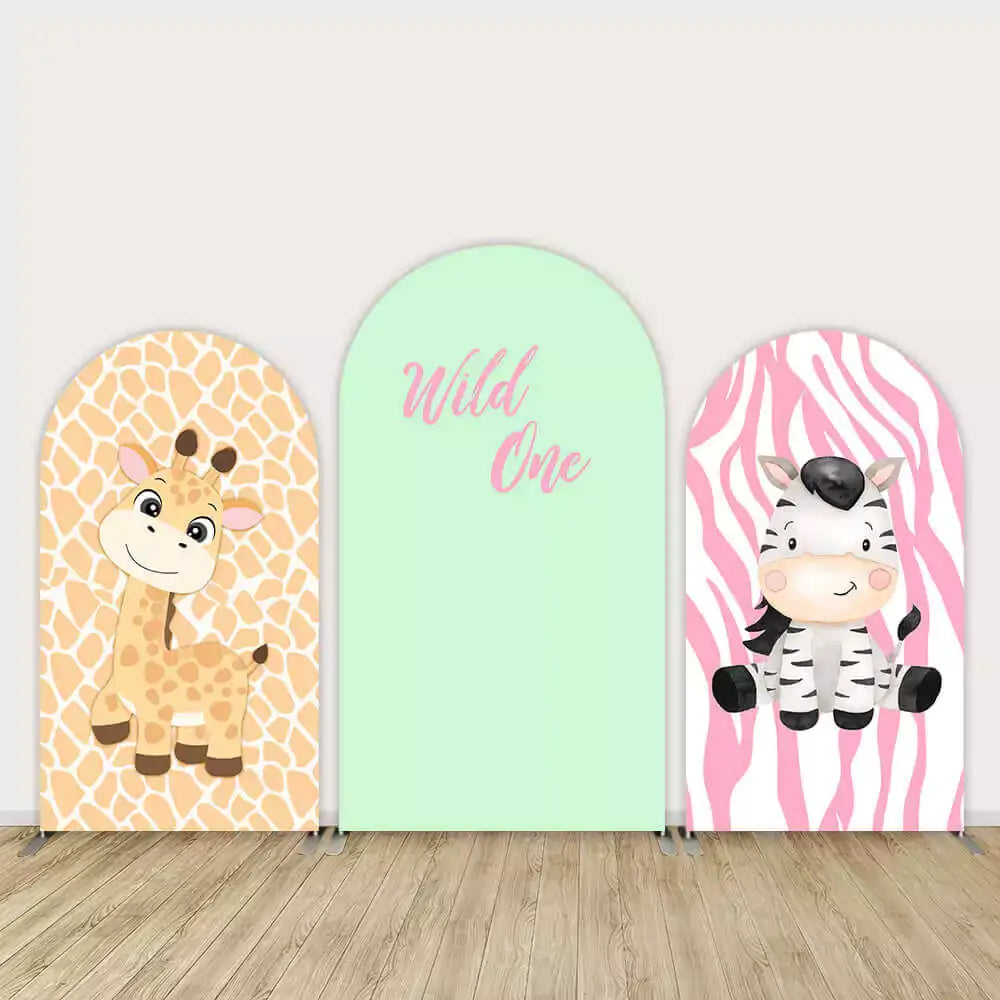 Three-panel Wild One safari birthday backdrop featuring cute cartoon giraffe, smiling zebra, and mint green panel with pink “Wild One” text.