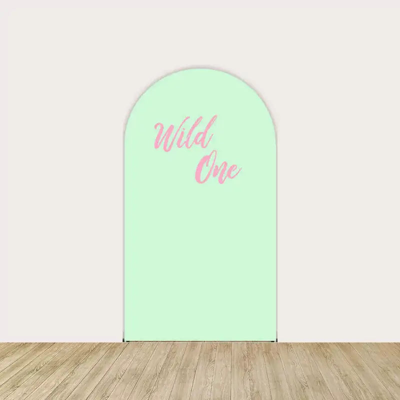 Center arch in mint green with pink script “Wild One” text—simple and sweet centerpiece.