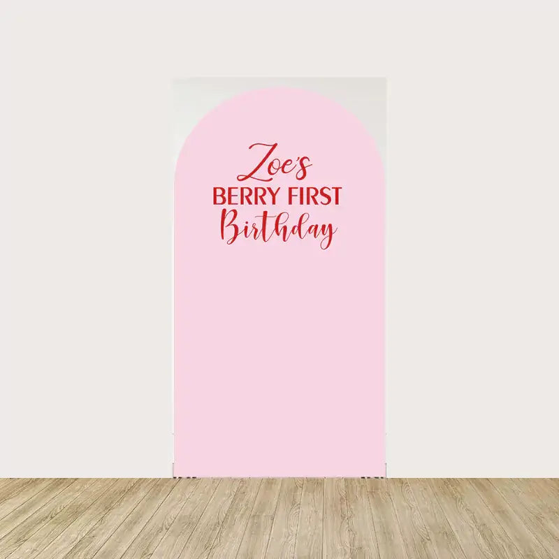 Center arch panel with soft pink background and red “Zoe’s Berry First Birthday” message—customizable for first birthday parties.