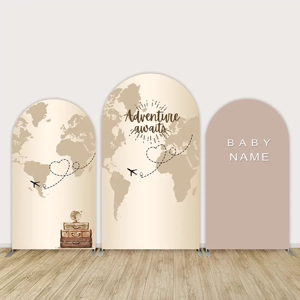 Neutral-toned arched backdrop set with a travel theme, featuring a world map, airplanes, and customizable baby name panel, perfect for baby showers or travel-inspired events.