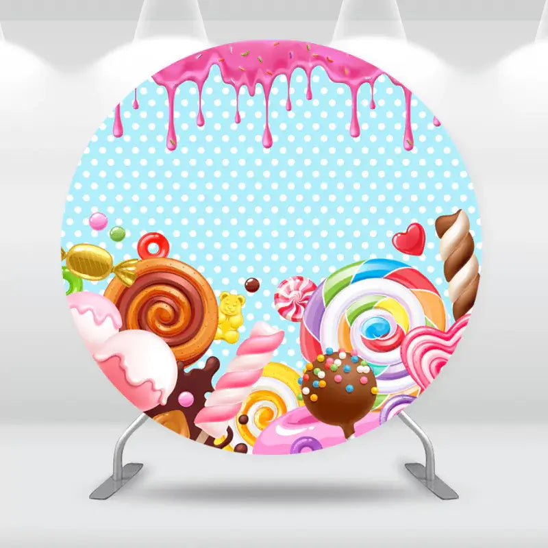 Round candy-themed backdrop with lollipops, candy swirls, and a pink drizzle design.