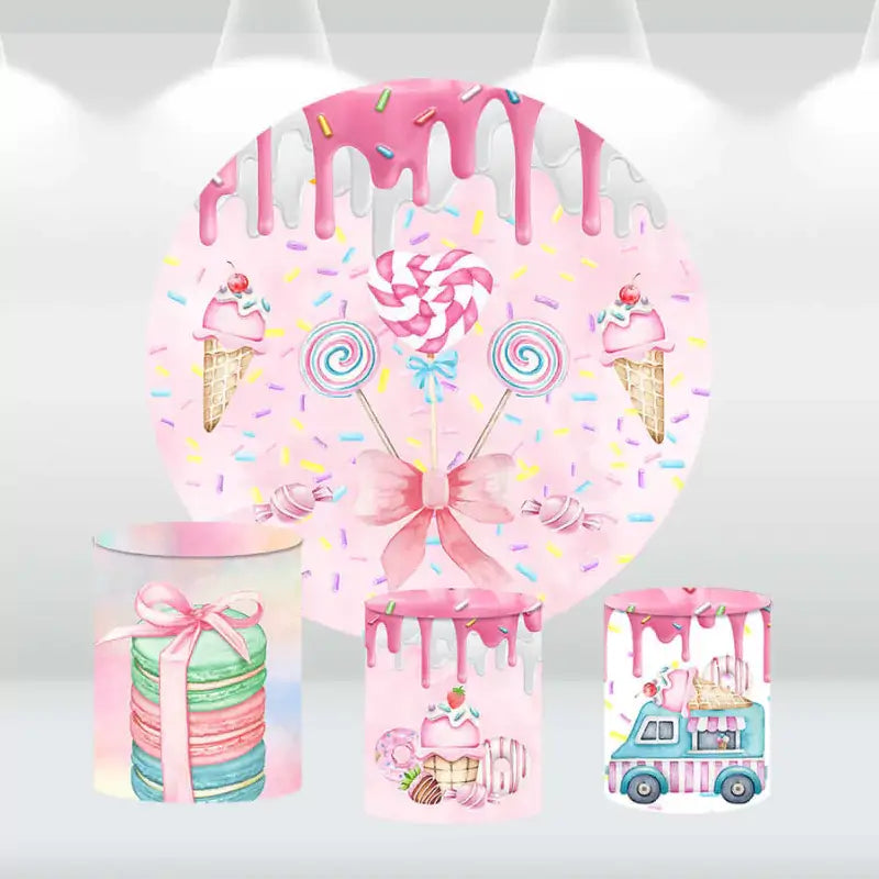 Candyland-themed party decor set with a pink candy backdrop and matching cylinder covers, featuring lollipops, ice cream, and macarons.