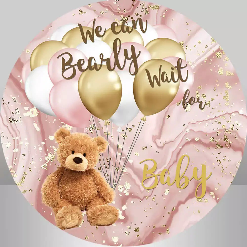 Round baby shower backdrop with a cute teddy bear, pink and gold balloons, and a marble-patterned background with gold accents.