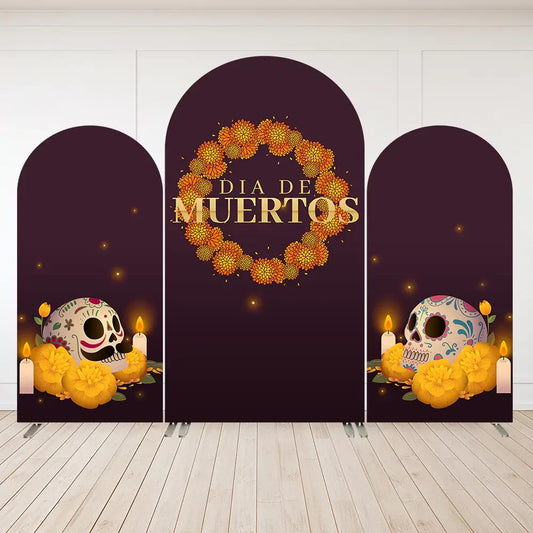 A Día de Muertos-themed arched backdrop set featuring marigold wreaths, sugar skulls, and candles against a maroon background, ideal for Day of the Dead celebrations.