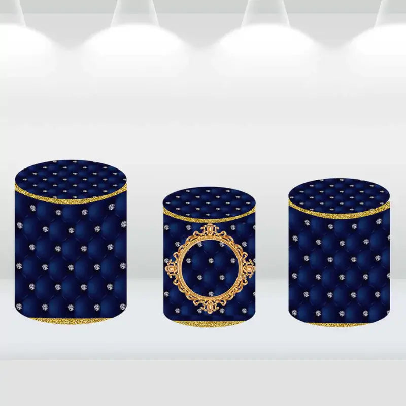 Set of navy blue cylinder covers with luxurious gold accents and tufted design.