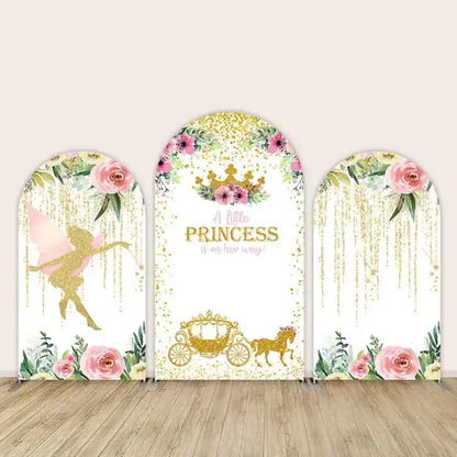 Baby shower backdrop set with 'A Little Princess is on her way!' message, featuring floral and gold accents with a fairy and royal carriage."