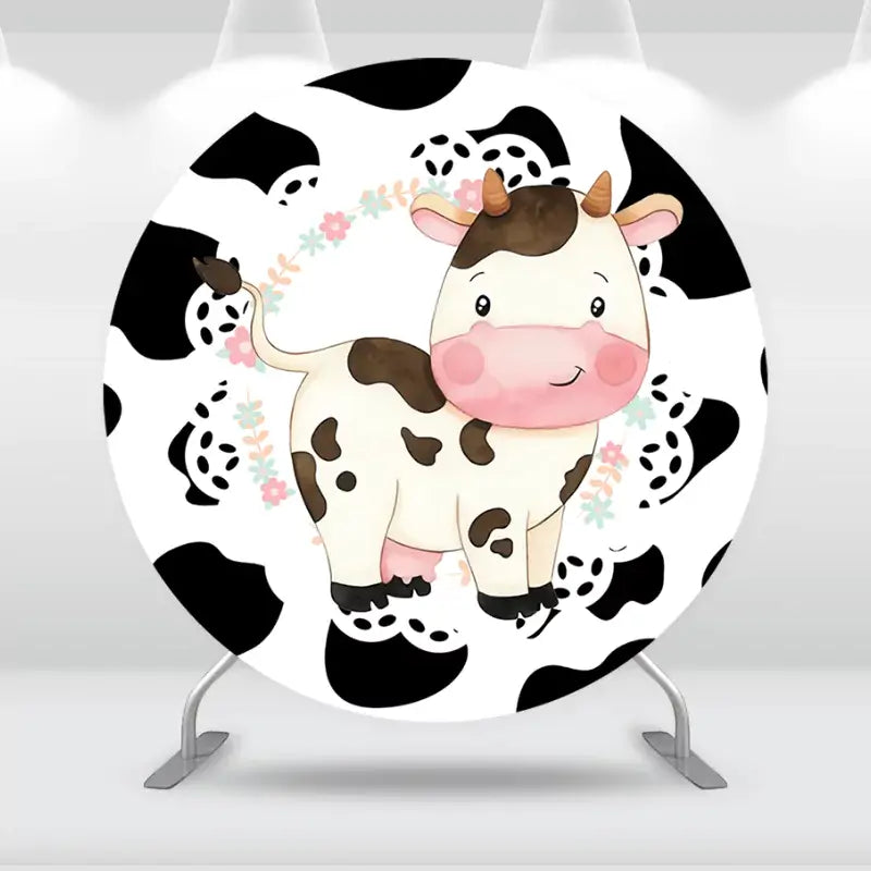 Round cow-themed party backdrop featuring a cute cow with a bow.