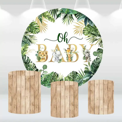 Tropical jungle-themed baby shower backdrop featuring safari animals and wooden-style cylinder covers.