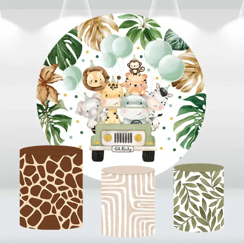 Safari-themed baby shower backdrop with jungle animals in a jeep and matching cylinder covers featuring giraffe print, zebra stripes, and leafy designs