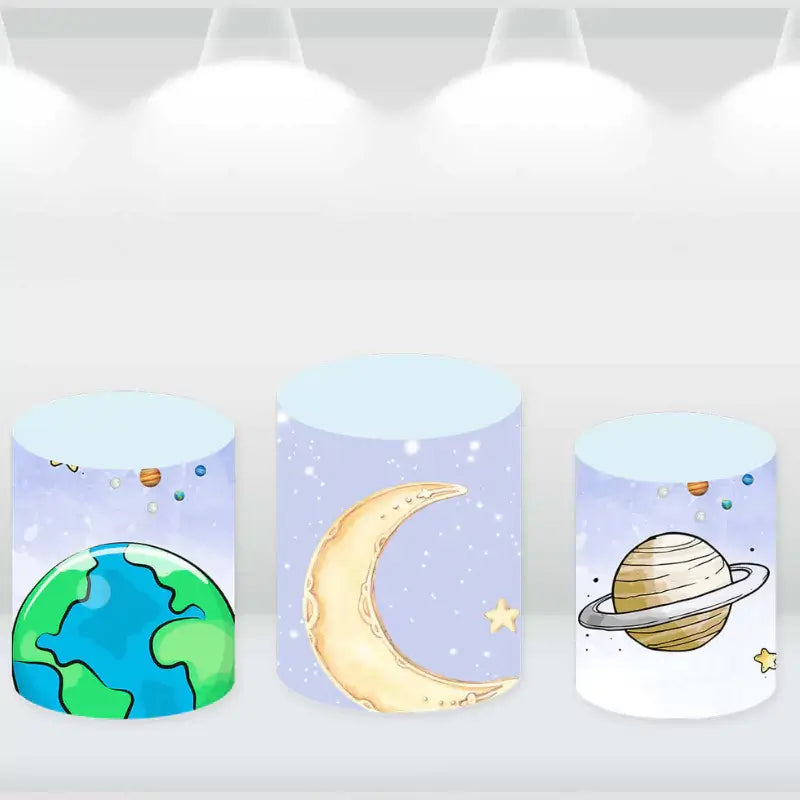 Set of three cylinder covers featuring designs of Earth, a crescent moon, and Saturn, matching the outer space-themed party backdrop.