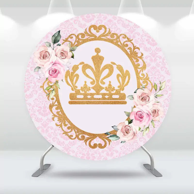 Elegant round backdrop featuring a golden crown and floral accents for a royal-themed baby shower.