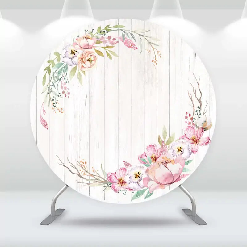 Chic floral-themed backdrop with a wreath of flowers on a distressed wood background, ideal for weddings and showers.