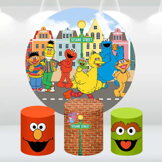 Colorful Sesame Street party decor set with a round backdrop of Sesame Street characters and cylinder covers featuring Elmo, Oscar the Grouch, and the Sesame Street sign.