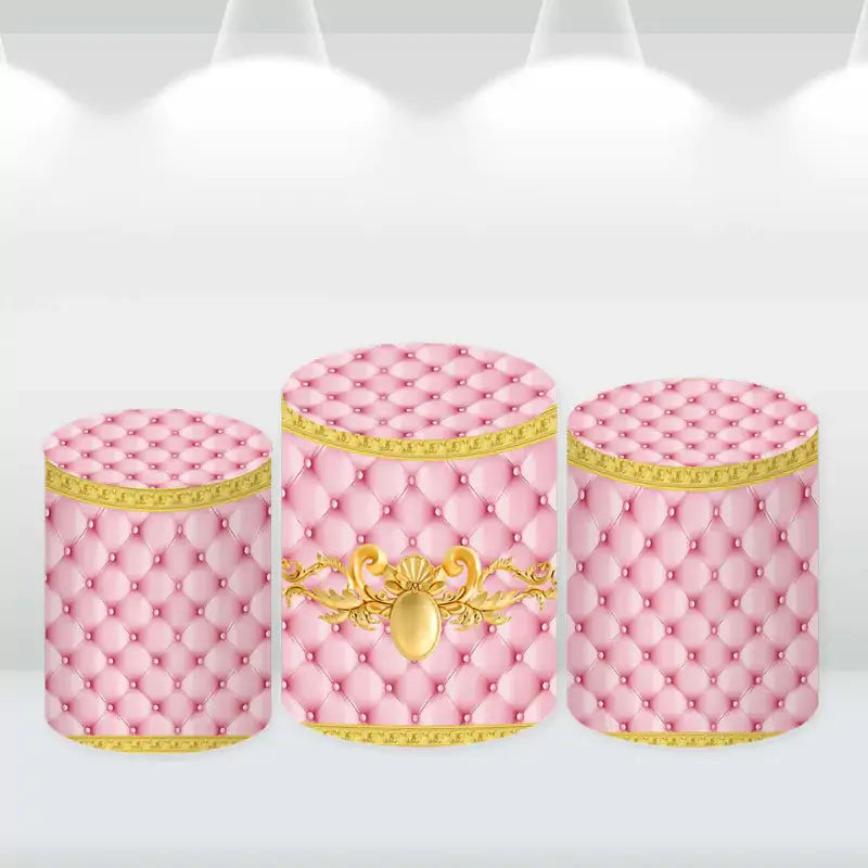 Pink tufted cylinder covers with gold detailing, complementing the princess-themed baby shower backdrop.