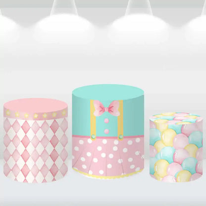 Set of three cylindrical pedestal covers with matching patterns: pink diamonds, polka dots, and pastel balloon designs.