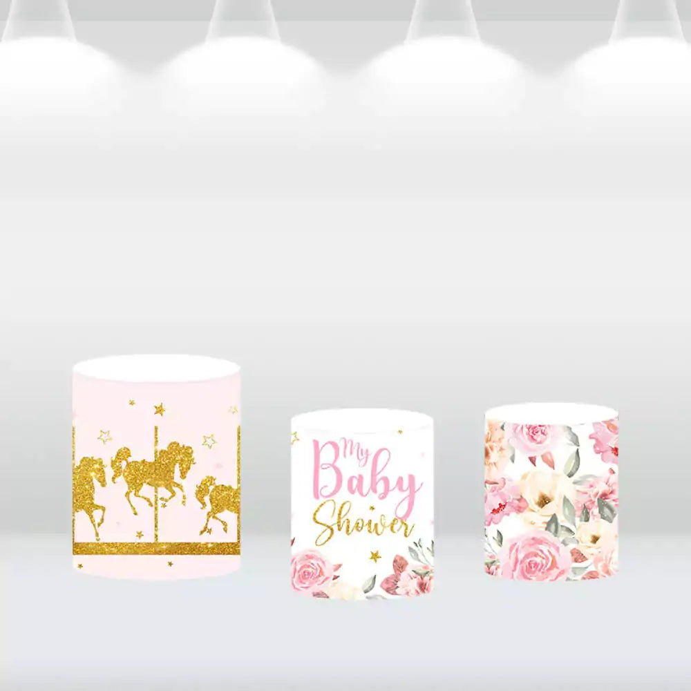 Set of three cylinder pedestal covers featuring carousel designs and floral accents, matching a baby shower carousel backdrop.