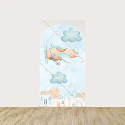 Arch panel with watercolor orange and blue airplane flying among fluffy clouds and stars—houses and trees line the bottom of the scene.