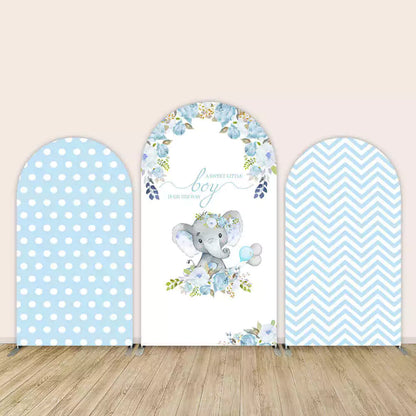 Three-panel baby shower arch backdrop for a boy with elephant illustration, blue floral design, polka dots, and chevron pattern.