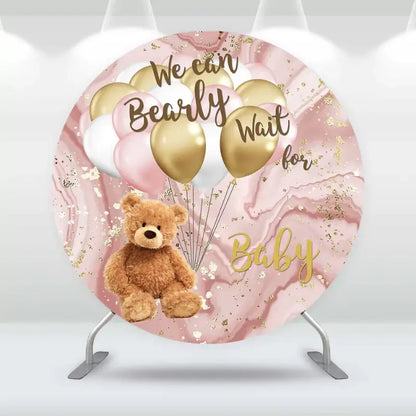 Round baby shower backdrop with plush teddy bear, pink and gold balloons, and marbled background – features ‘We Can Bearly Wait for Baby’ text in elegant script