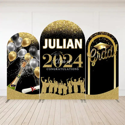 Three-panel graduation-themed arch backdrop set in black and gold with “Julian Class of 2024,” champagne bottle, balloons, and graduate silhouettes.