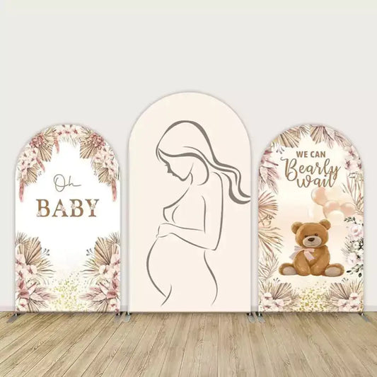 Three-panel baby shower arch backdrop set with neutral pampas florals, minimalist pregnant silhouette, and teddy bear “We Can Bearly Wait” design.