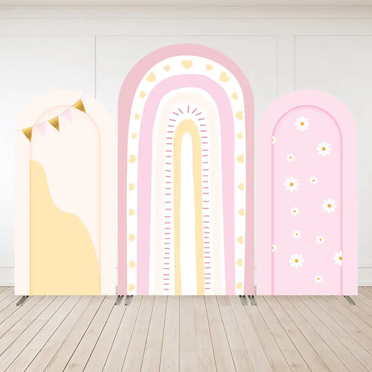 Three pastel boho arch backdrop panels featuring pink rainbow with hearts, blush bunting banner, and daisy flower print—ideal for girls' parties.