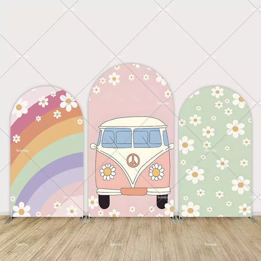 Three-piece boho arch backdrop featuring a rainbow with daisies, a peace sign flower van, and a green daisy pattern panel.