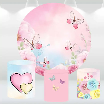 Butterfly and floral-themed round backdrop with three matching cylindrical pedestal covers featuring heart, butterfly, and floral designs.