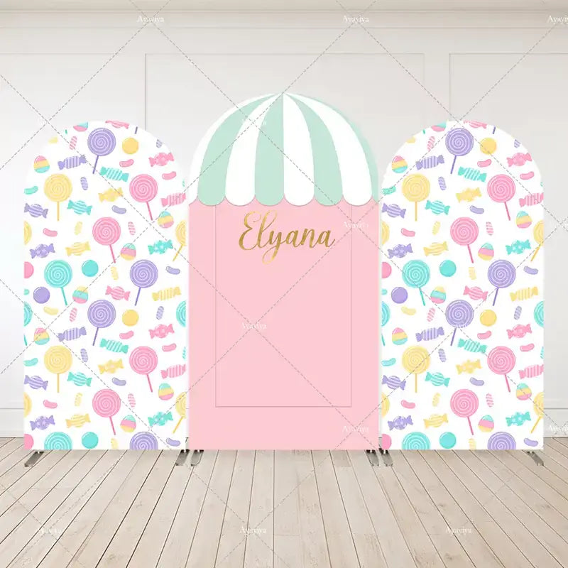 Candy shop-themed birthday backdrop set with pastel-colored candies and personalized name panel