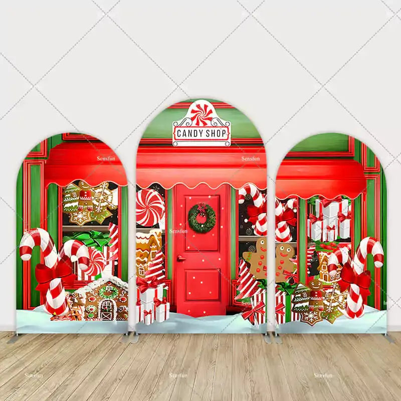 Three-piece arch wall backdrop depicting a red and green candy shop with candy canes, gingerbread cookies, and peppermint decorations.
