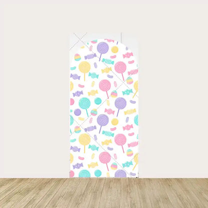 Center panel of a personalized candy-themed backdrop with the name "Elyana" in gold, surrounded by pastel candies and lollipops.