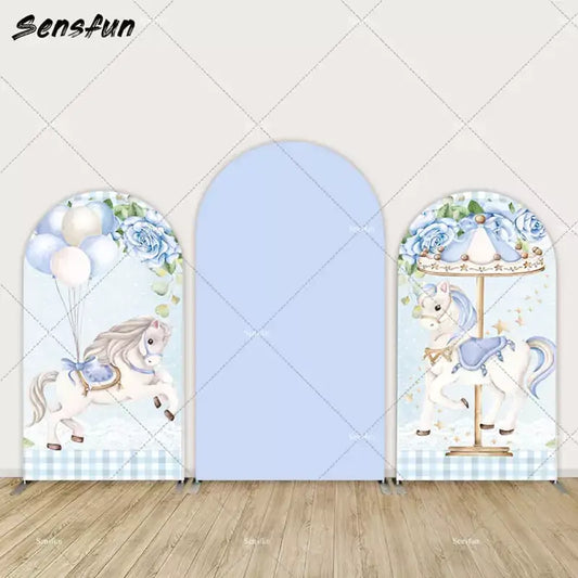 Three-panel blue arch backdrop set with carousel horse illustrations, balloons, blue roses, and gingham pattern—perfect for baby showers.