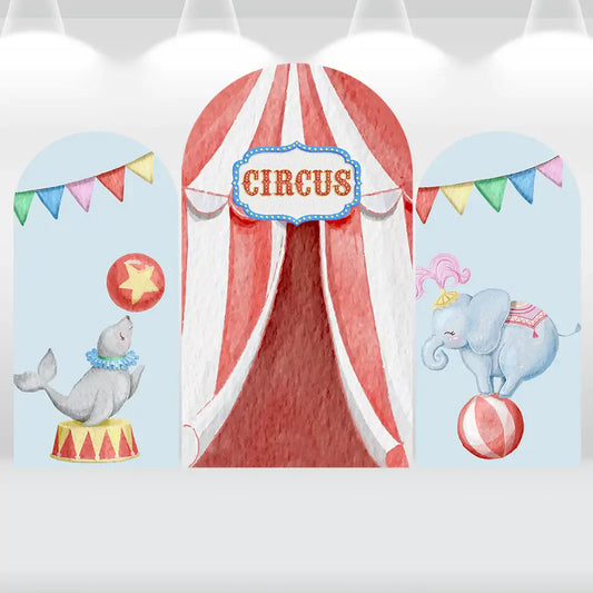 Three-panel circus-themed arch backdrop featuring a red and white striped circus tent, playful seal balancing a ball, elephant standing on a ball, and colorful pennant banners.