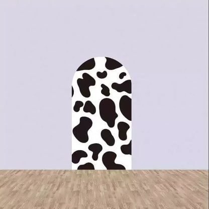 Left arch panel with bold black and white cow spots—classic farm design perfect for barnyard-themed party decor.