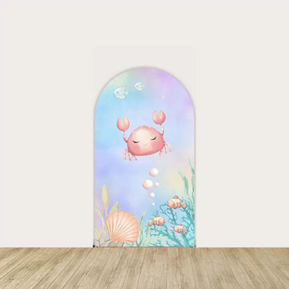 Right panel with smiling crab, seashells, and soft sea plants on a pastel blue-purple background—perfect for under-the-sea baby showers.
