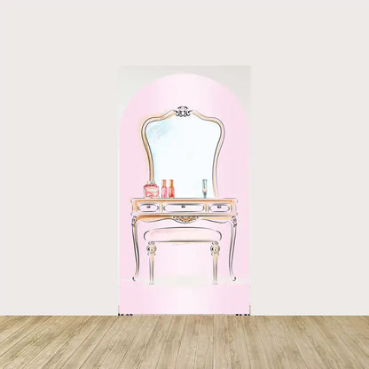 Arch backdrop with vintage-style vanity table and mirror, decorated with bottles and cosmetics—perfect for girl’s makeup birthday theme.