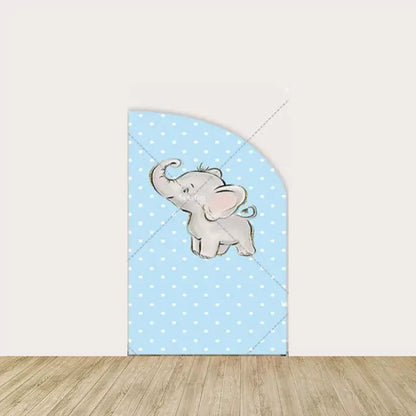 Blue polka dot backdrop with a baby elephant lifting its trunk, complementing the cute and playful theme of the set.