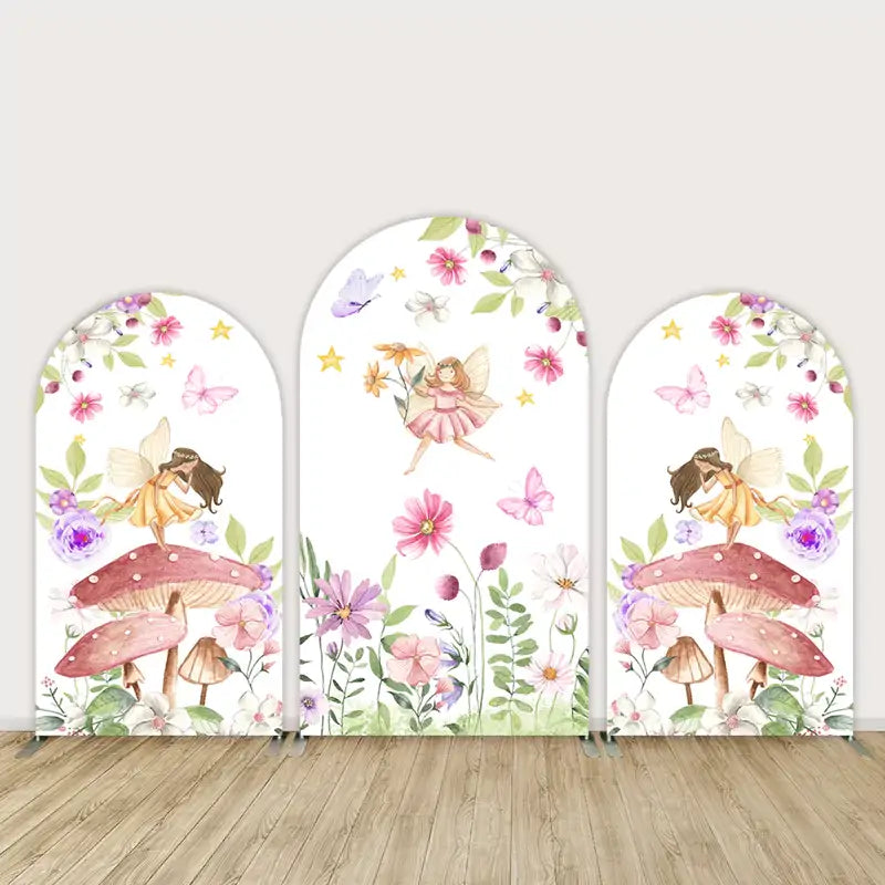 Fairy-themed arched backdrop set with whimsical flowers, mushrooms, butterflies, and fairies