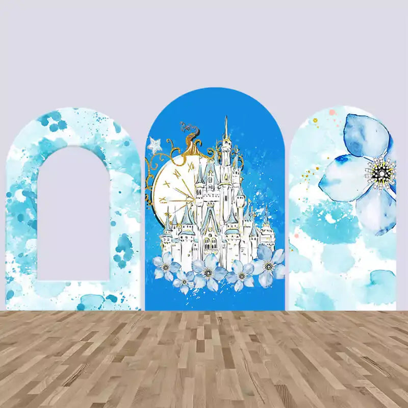 Fairytale-themed backdrop set featuring a watercolor castle, clock, and floral designs in blue tones, perfect for princess or enchanted-themed parties.