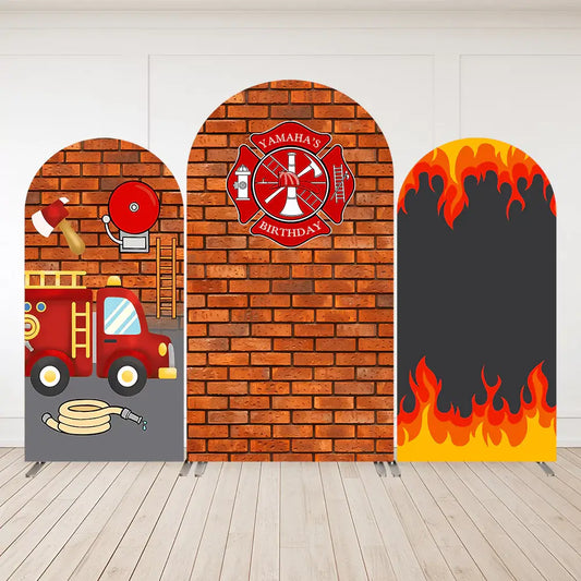 Firefighter birthday party arch backdrops with firetruck, red brick wall, firefighter badge, and flame design.