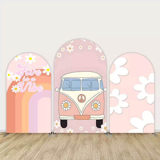 Three-piece arch wall backdrop featuring retro peace van, "Five is a Vibe" rainbow text, and daisy flower illustrations on a pink background.