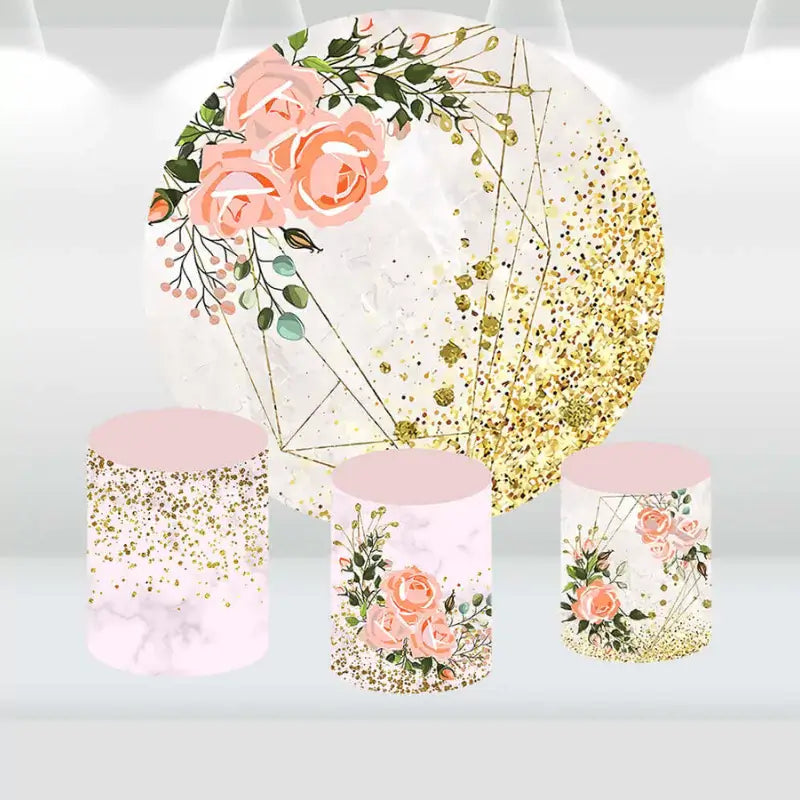 Round backdrop featuring pink roses, gold glitter accents, and geometric patterns, with matching cylinder covers in floral and marble designs.