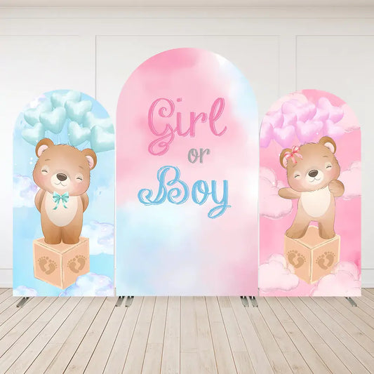 Gender reveal party backdrop with teddy bears, one in blue and one in pink, surrounded by pastel clouds and blocks.