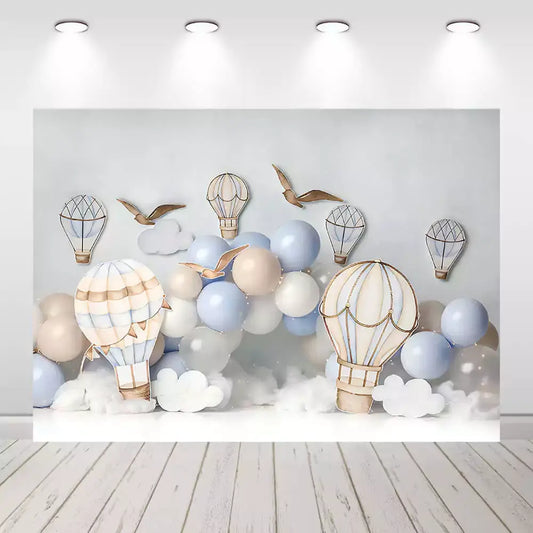 Hot air balloon party backdrop with blue, beige, and white balloons, soft clouds, and birds – perfect for baby showers, birthdays, or gender-neutral celebrations