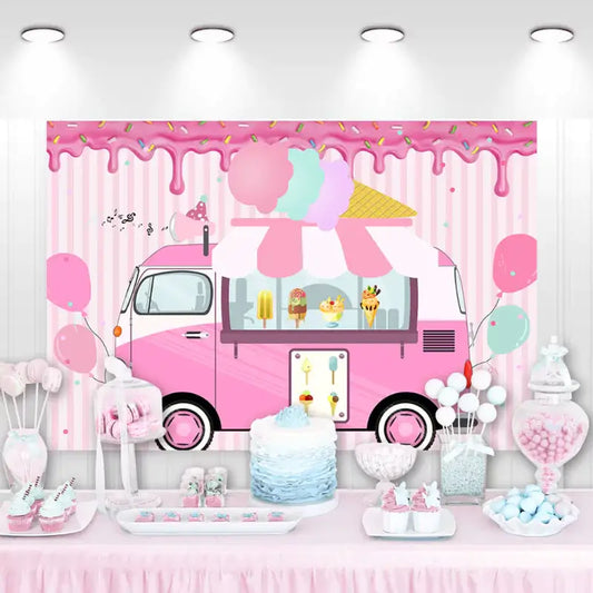 Pink ice cream truck-themed party backdrop with desserts and balloons, perfect for a sweet and fun party.