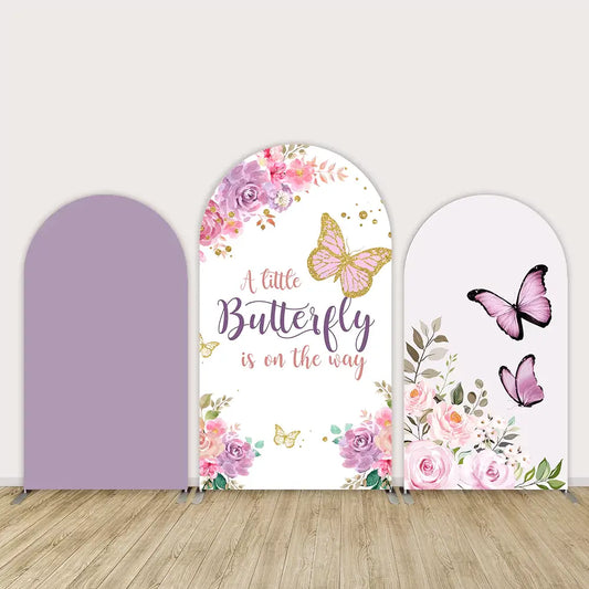 Butterfly-themed baby shower backdrop set with floral accents and “A Little Butterfly Is on the Way” text