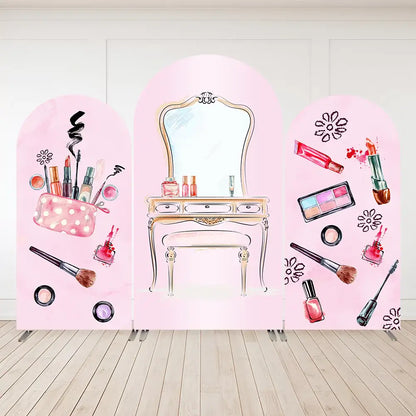 Three-panel pink makeup backdrop with vanity table, brushes, lipsticks, and nail polish illustrations—ideal for spa or beauty-themed party decor.