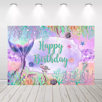 Underwater-themed mermaid birthday party backdrop with a vibrant mermaid tail and colorful coral.